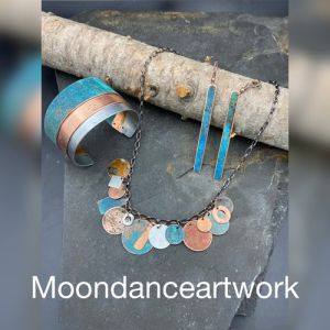 Wearable art created in Montana using recycled copper, metals & found wood.